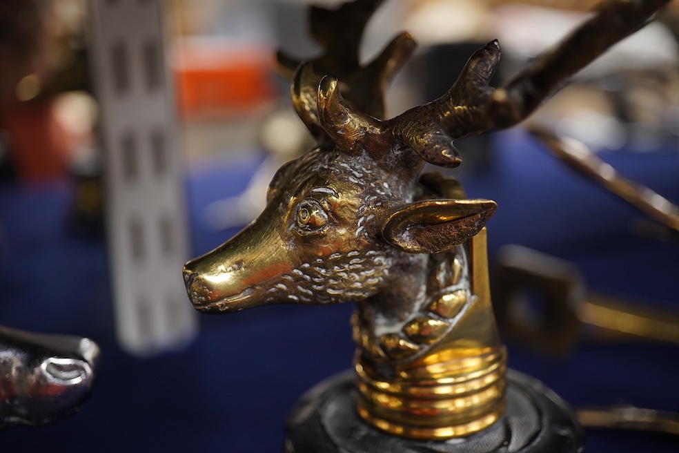 Five chrome and brass car radiator mascots; three in the form of stags’ heads, a stag standing on an oak branch and an Art Deco leading gazelle. Condition - fair, some losses to chrome plating.